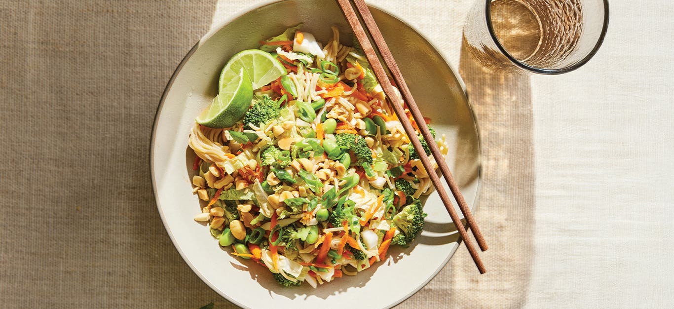 A bowl of Thai-Style Slaw with Peanuts and Ramen Noodles with chopsticks on the side
